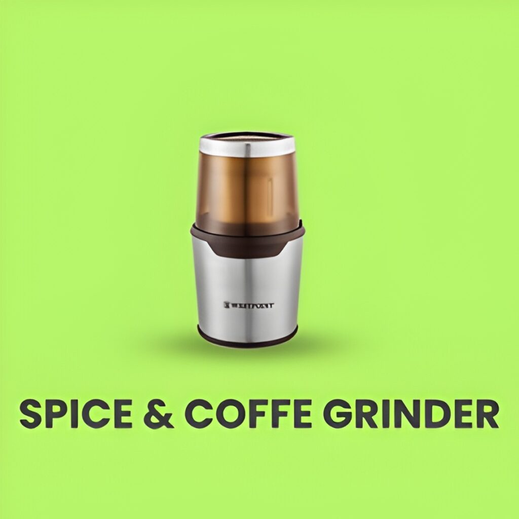 A coffee & spice blender with freshly ground coffee beans beside it.